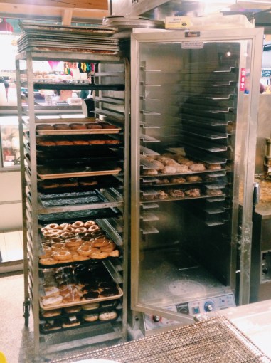 Some on deck to the fryer, others to be served. The bottom rack on the right side is full of apple fritters to-be-fried. They were flying out of the display case!