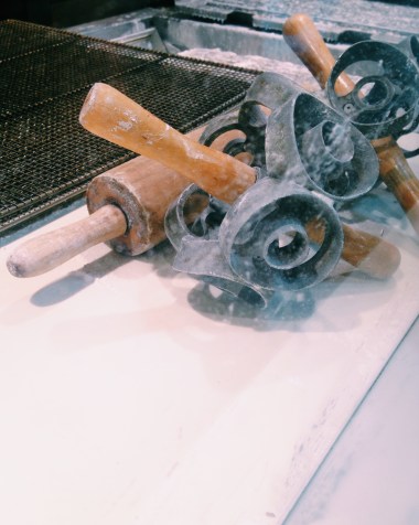 Check out that equipment! Doughnut cutting efficiency at its coolest.